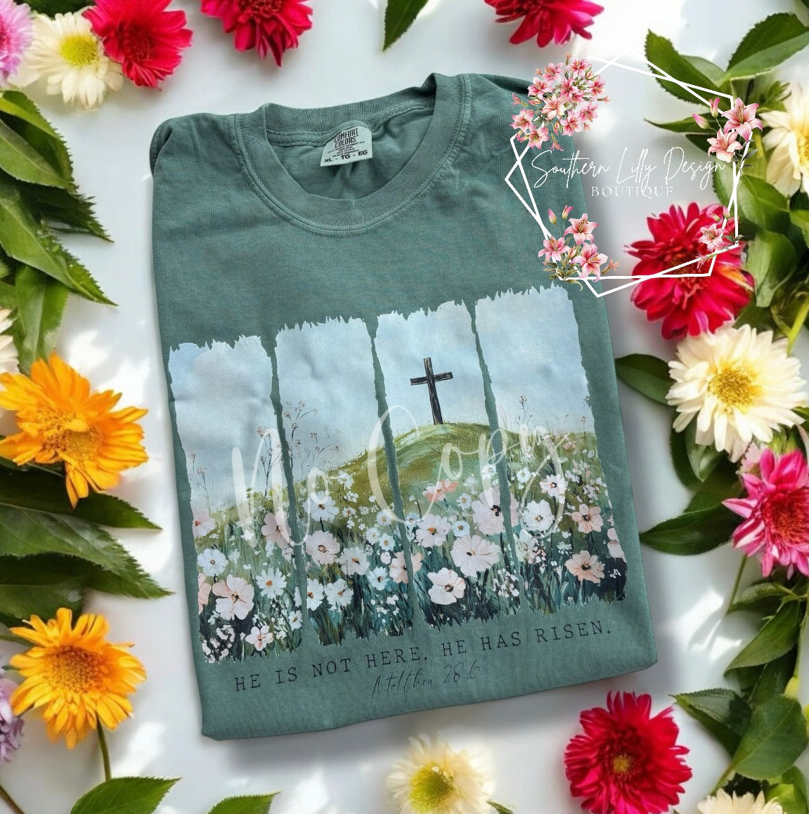 Christian He Is Risen t-shirt – Comfort Colors Easter faith-based graphic tee with Matthew 28:6 Bible verse and floral cross design.